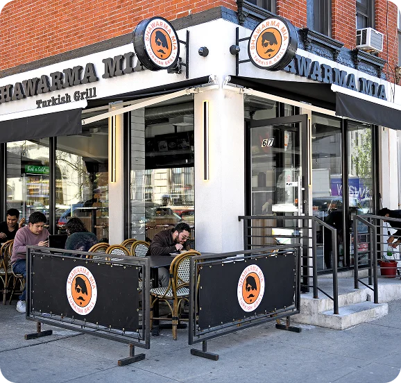 Shawarma Mia Turkish Grill storefront with sidewalk seating and diners
